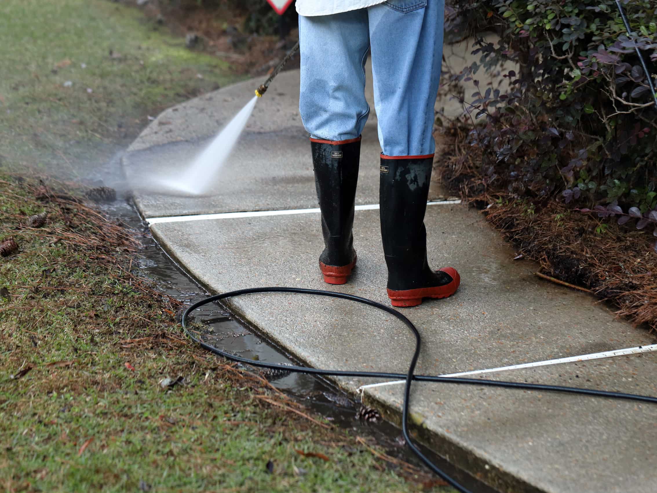 This is a photo of a pathway being cleaned using a pressure washer