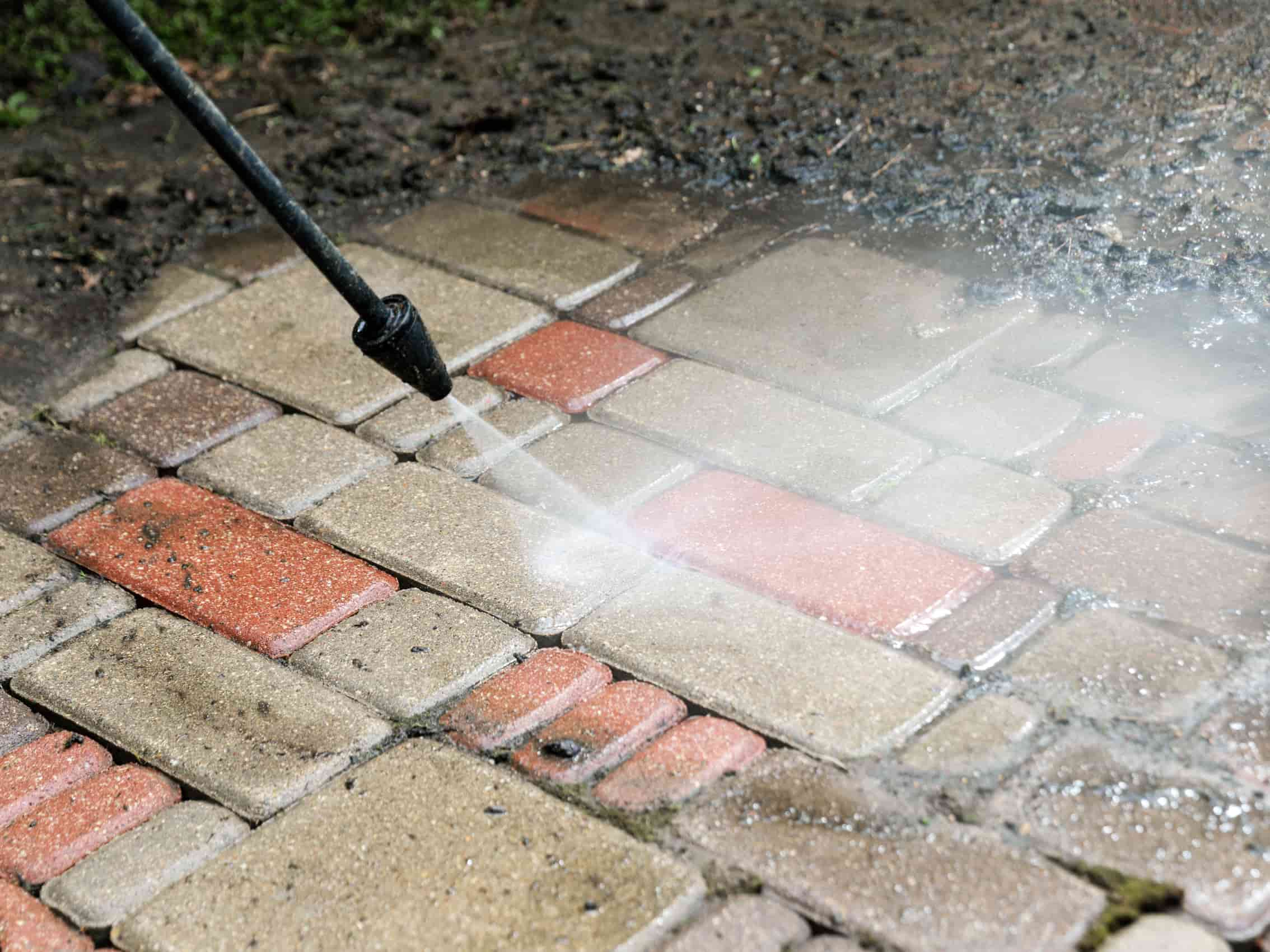 This is a photo of a driveway being cleaned using a pressure washer
