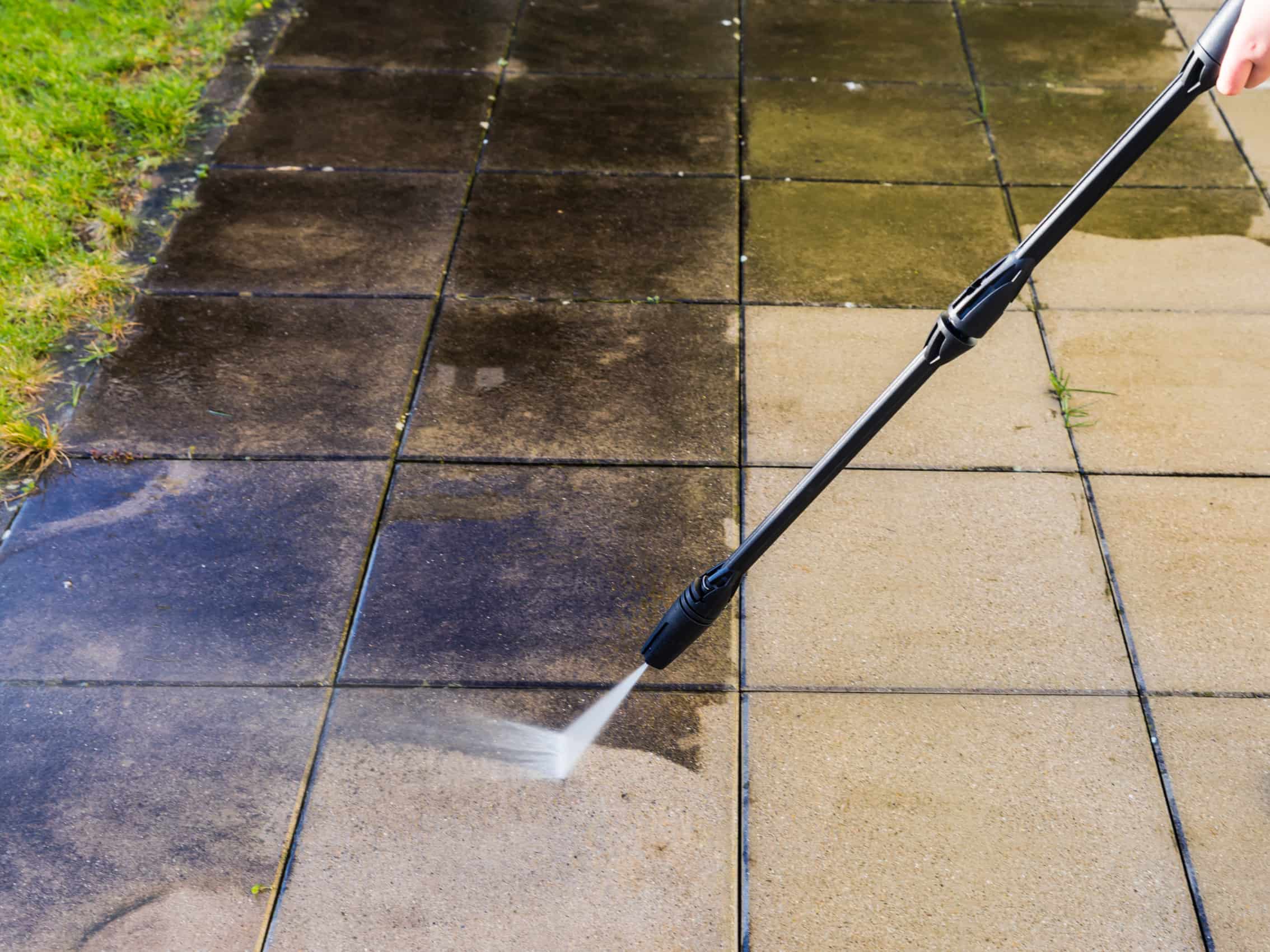 This is a photo of a patio being cleaned using a pressure washer